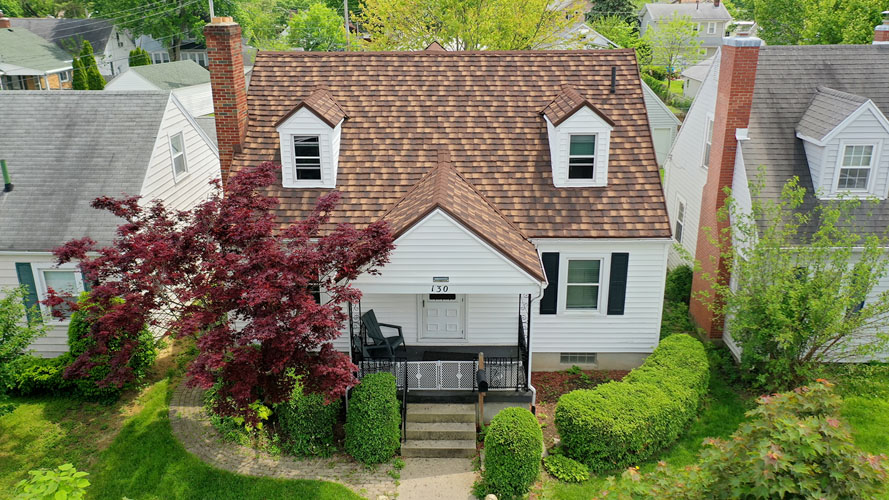 Cape cod home after new stone-coated metal shake roof installation